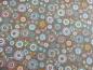 Preview: Patchworkstoff aus der Serie Doodle Days mit Kreisen und Blumen auf taupe farbenen Untergrund von Makower.